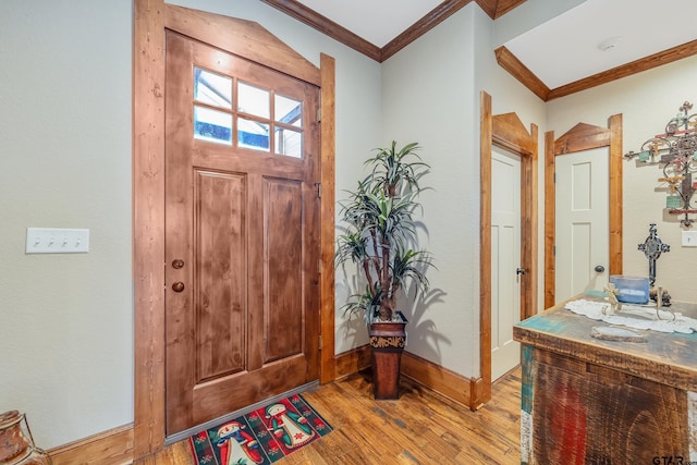 entryway featuring crown molding and light hardwood / wood-style flooring