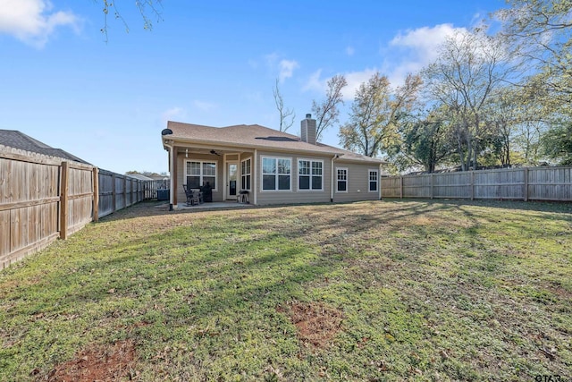 back of property featuring a patio, ceiling fan, and a lawn