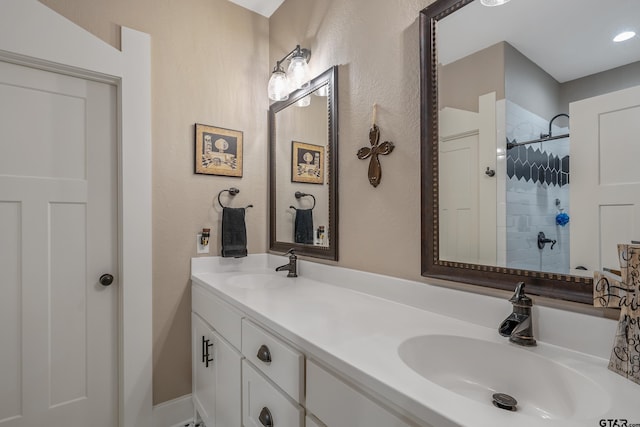 bathroom featuring vanity and tiled shower