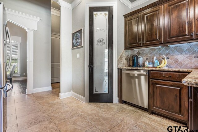 bar featuring ornamental molding, backsplash, appliances with stainless steel finishes, and decorative columns