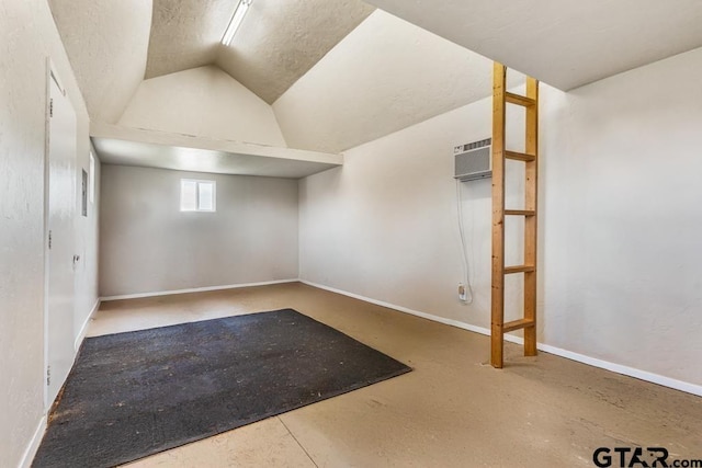 basement featuring an AC wall unit and baseboards