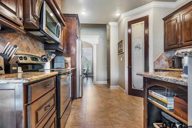 kitchen with decorative backsplash, light stone counters, and stainless steel appliances