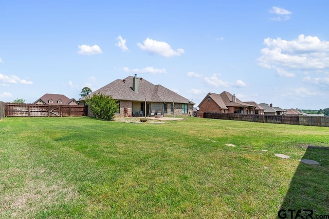 view of yard featuring a patio area and a fenced backyard
