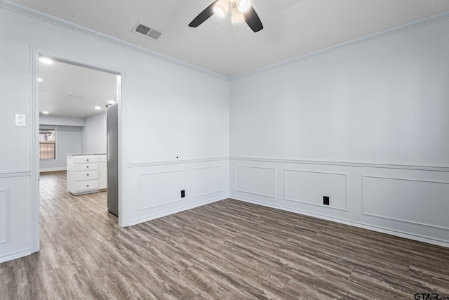 unfurnished room with ceiling fan, wood-type flooring, and ornamental molding