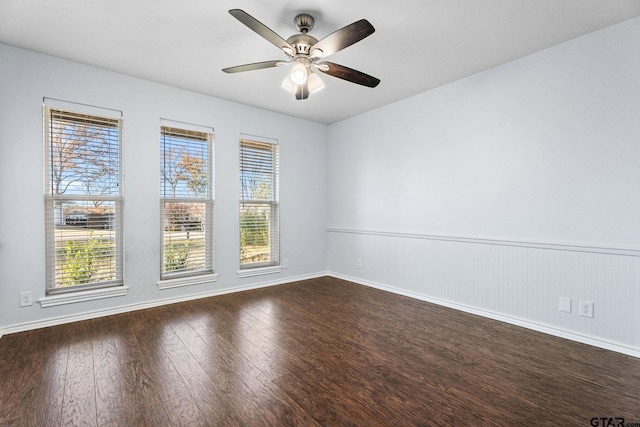 spare room featuring ceiling fan and dark wood-type flooring