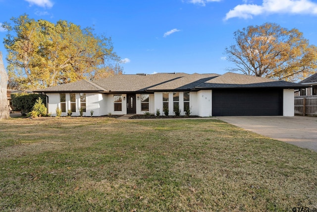 view of front of home with a garage and a front lawn