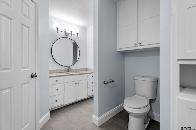 bathroom featuring tile patterned flooring, vanity, and toilet