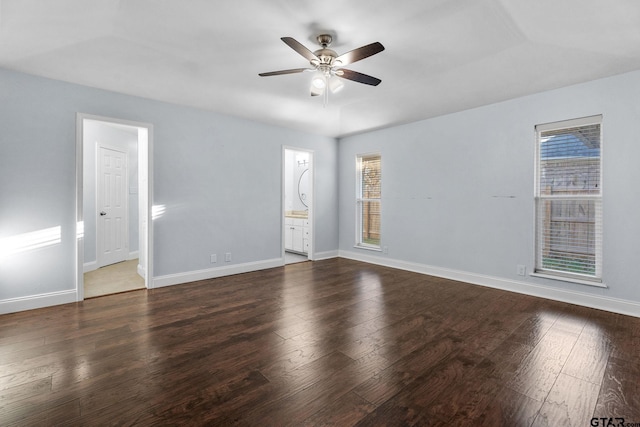 unfurnished room with dark hardwood / wood-style floors, ceiling fan, and a healthy amount of sunlight