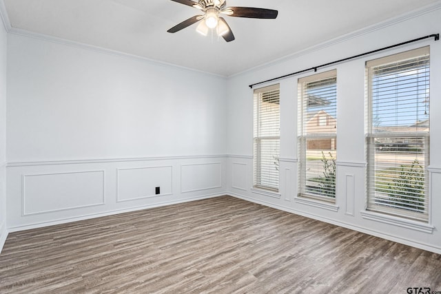 unfurnished room featuring hardwood / wood-style floors, ceiling fan, and crown molding