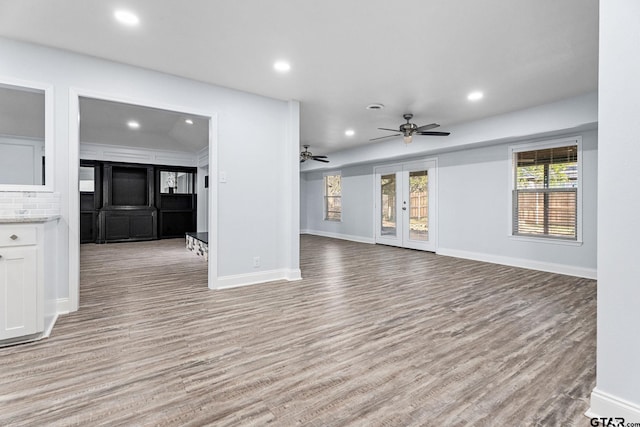 unfurnished living room featuring ceiling fan, french doors, light hardwood / wood-style floors, and ornamental molding