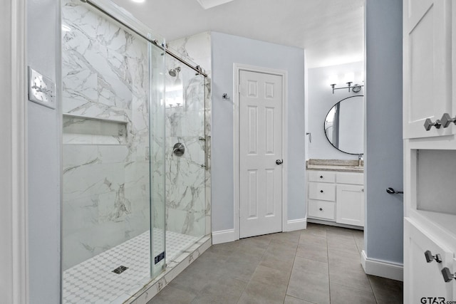 bathroom with tile patterned floors, vanity, and a shower with door