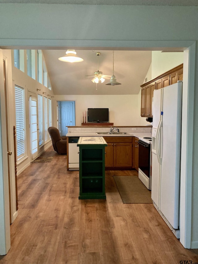 371 Wildwood Trl, Holly Lake Ranch, TX 75765 - kitchen with white appliances, vaulted ceiling, a sink, brown cabinetry, and open floor plan