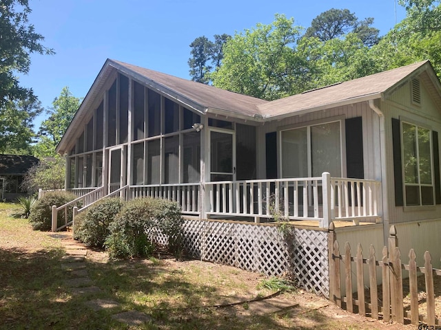 back of property with a sunroom