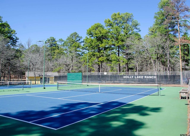 371 Wildwood Trl, Holly Lake Ranch, TX 75765 - view of tennis court featuring community basketball court and view of wooded area