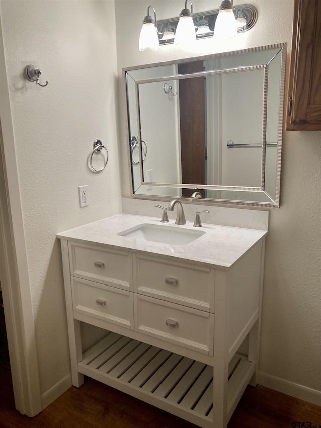 371 Wildwood Trl, Holly Lake Ranch, TX 75765 - bathroom featuring baseboards, wood finished floors, vanity, and a textured wall