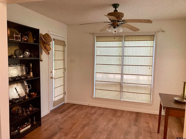 interior space with hardwood / wood-style floors, a textured ceiling, and ceiling fan