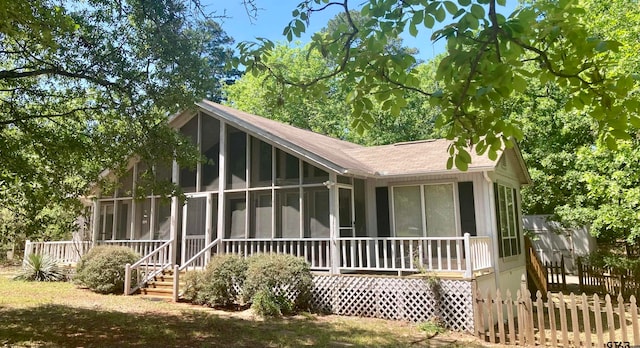 back of property with a sunroom