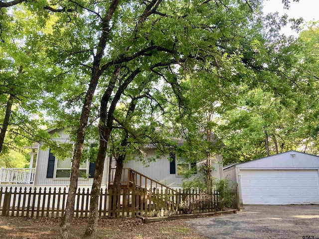 371 Wildwood Trl, Holly Lake Ranch, TX 75765 - view of front of home with a detached garage and a fenced front yard