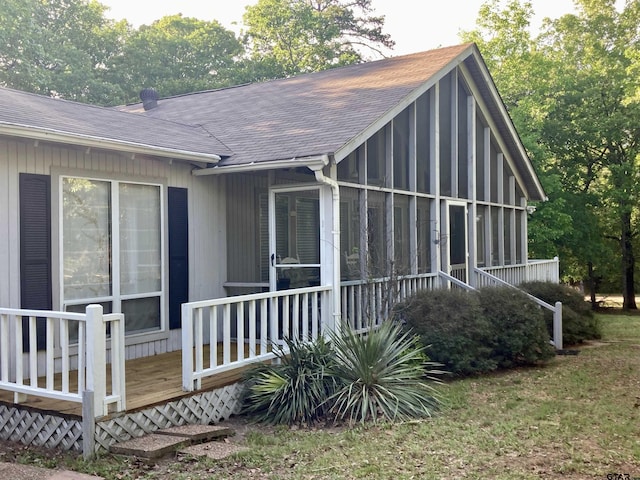 371 Wildwood Trl, Holly Lake Ranch, TX 75765 - view of property exterior with roof with shingles, a sunroom, and a deck