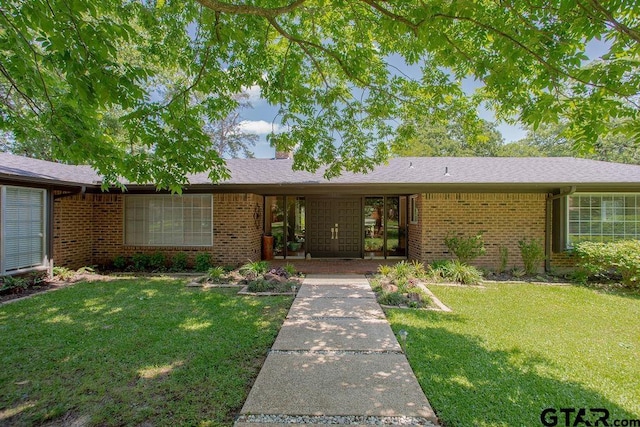 225 Texas Dr, Hideaway, TX 75771 - ranch-style home with brick siding and a front lawn