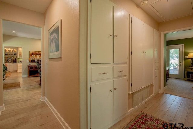 225 Texas Dr, Hideaway, TX 75771 - corridor featuring light wood-type flooring, baseboards, and attic access