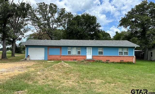 ranch-style home featuring a garage and a front lawn