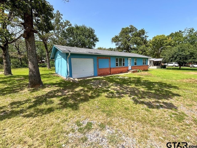 single story home featuring a garage and a front yard