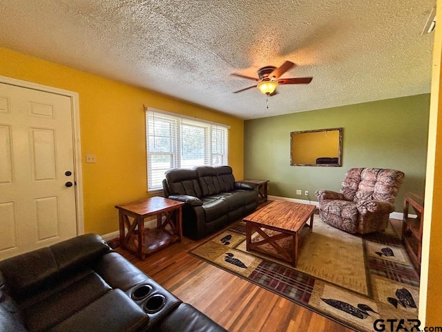 living room featuring hardwood / wood-style floors, a textured ceiling, and ceiling fan