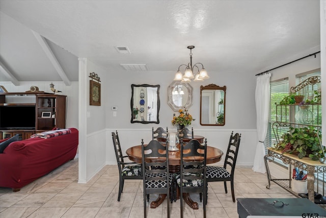 dining area with wainscoting, an inviting chandelier, and visible vents