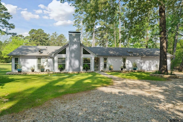rear view of property featuring a yard and a chimney
