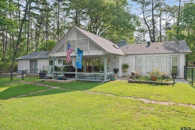 rear view of property featuring a gate, a chimney, covered porch, fence, and a lawn