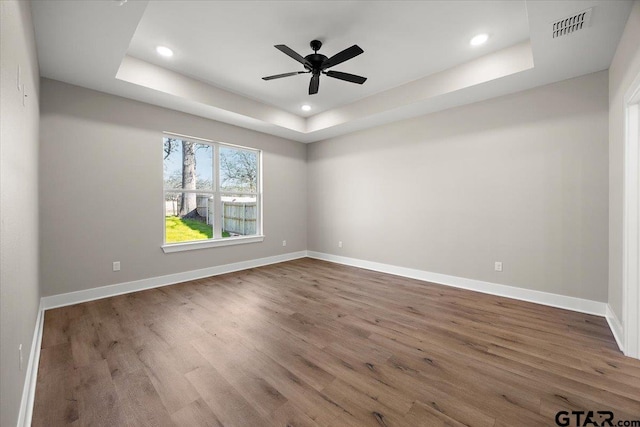 248 Kaul Ln, Bullard, TX 75757 - empty room featuring a tray ceiling, wood finished floors, recessed lighting, and ceiling fan