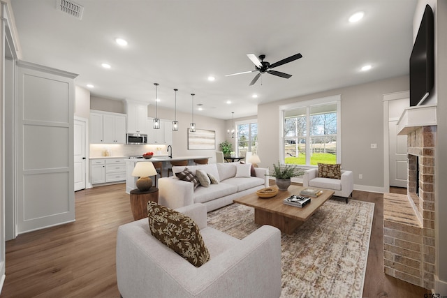 248 Kaul Ln, Bullard, TX 75757 - living area with ceiling fan, recessed lighting, dark wood-style flooring, and a brick fireplace