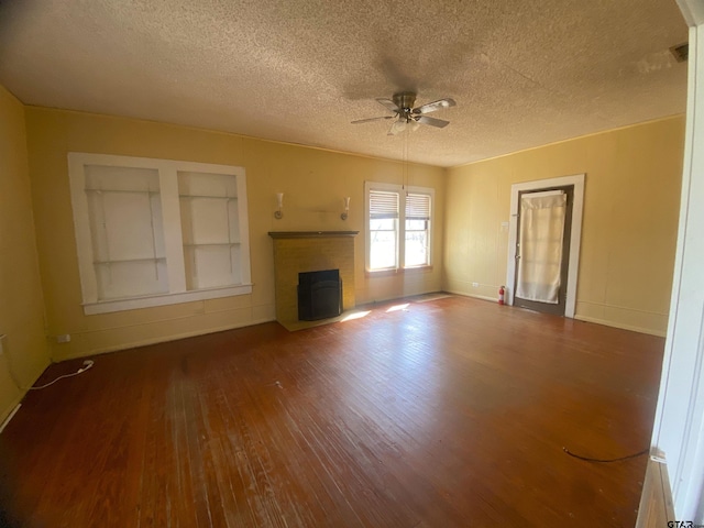 unfurnished living room featuring a textured ceiling, wood-type flooring, and ceiling fan