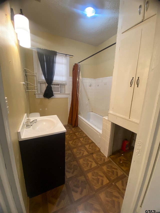 bathroom with shower / tub combo with curtain, vanity, parquet flooring, and a textured ceiling