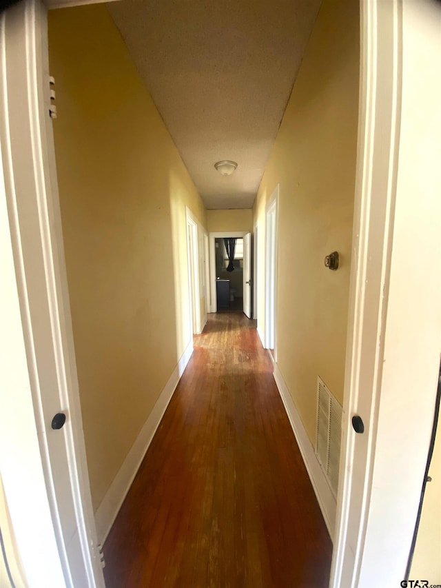 corridor featuring dark hardwood / wood-style flooring