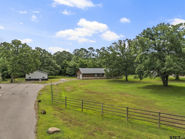 view of front of property featuring a rural view and a front yard