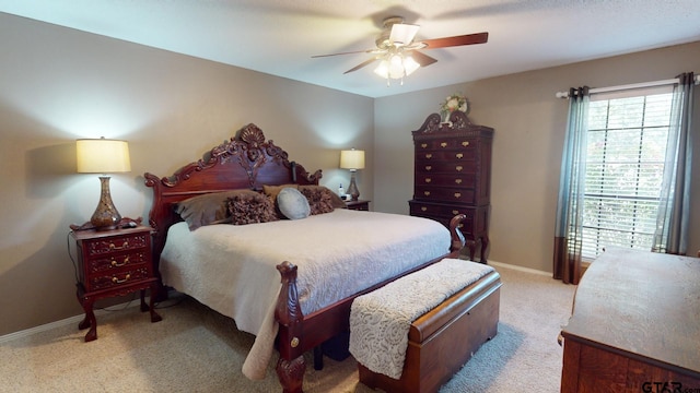 bedroom featuring light carpet and ceiling fan