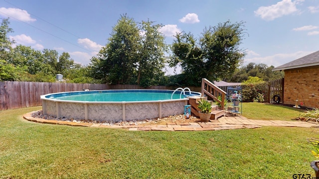 view of swimming pool featuring a lawn