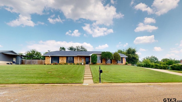 ranch-style home with a front lawn