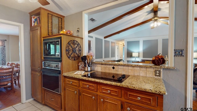 kitchen featuring decorative backsplash, black appliances, light stone counters, light tile patterned floors, and lofted ceiling with beams