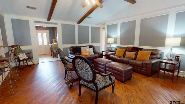 living room with ceiling fan, vaulted ceiling with beams, and light hardwood / wood-style flooring