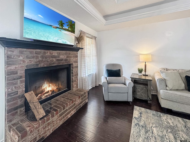 living area with dark wood finished floors and a brick fireplace