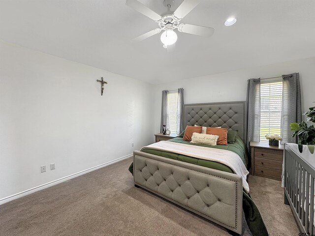 carpeted bedroom with baseboards and a ceiling fan