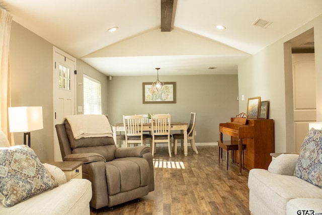 living area featuring visible vents, baseboards, lofted ceiling with beams, recessed lighting, and wood finished floors