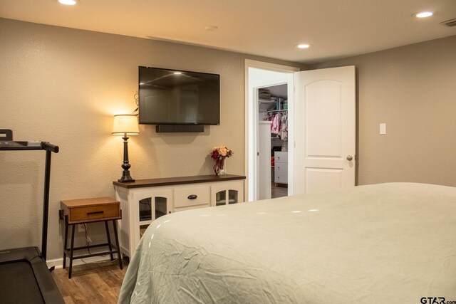 bedroom with visible vents, recessed lighting, and wood finished floors