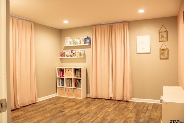 rec room with recessed lighting, baseboards, and wood finished floors