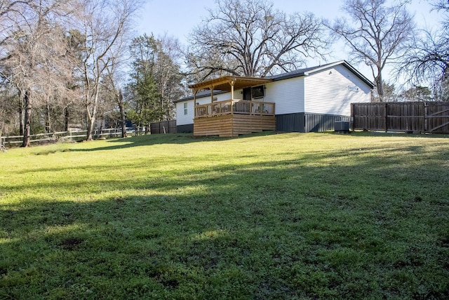 view of yard featuring a deck, central air condition unit, and a fenced backyard