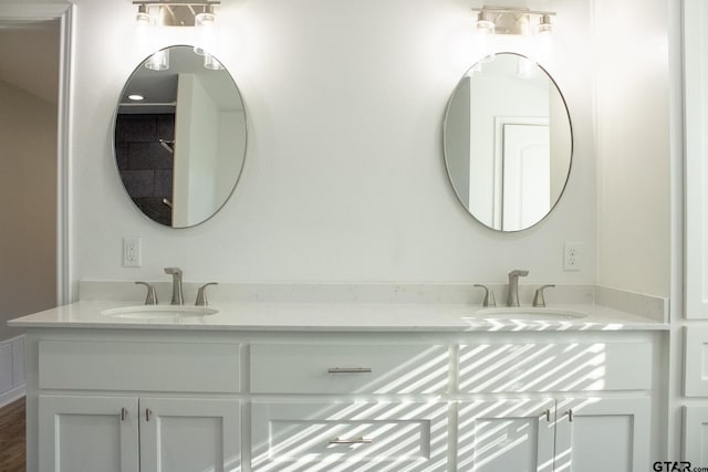 bathroom featuring double vanity and a sink