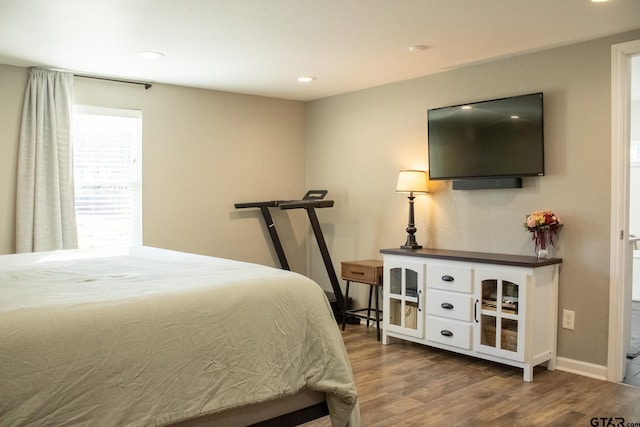 bedroom with recessed lighting, baseboards, and wood finished floors